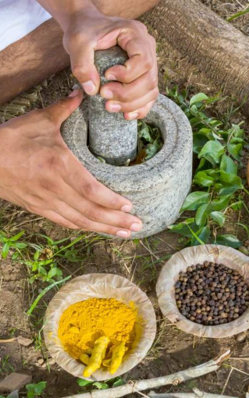 young-man-preparing-ayurvedic-medicine-traditional-ayurveda-herbs-acne-ss-Featured